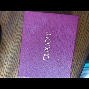 Woman’s Wine colored Buxton Tri Fold Wallet